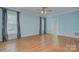 Spacious bedroom with wood floors, large windows, and blue painted walls at 8044 Hawk Crest Ct, Charlotte, NC 28270