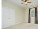This bedroom is well lit with light walls and light colored carpet, with a window and a closet at 8044 Hawk Crest Ct, Charlotte, NC 28270