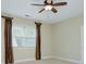 Bedroom featuring one window that lets in natural light and brown colored draperies, plus a fan at 8044 Hawk Crest Ct, Charlotte, NC 28270