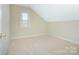 Well-lit bedroom featuring neutral walls, plush carpet, and a window to let in natural light at 8044 Hawk Crest Ct, Charlotte, NC 28270
