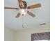 A ceiling fan with wooden blades and light fixture hanging from the ceiling at 8044 Hawk Crest Ct, Charlotte, NC 28270