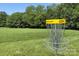Disc golf basket on green lawn, surrounded by lush trees, offering recreational activities at 8044 Hawk Crest Ct, Charlotte, NC 28270