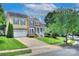 Charming two-story home featuring a well-manicured lawn, attached garage and a stone and yellow siding facade at 8044 Hawk Crest Ct, Charlotte, NC 28270