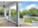 Inviting front porch with white pillars and railings offers a serene outdoor space with neighborhood views at 8044 Hawk Crest Ct, Charlotte, NC 28270