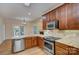 Modern kitchen with stainless steel appliances, granite countertops, and warm wood cabinetry for a gourmet cooking experience at 8044 Hawk Crest Ct, Charlotte, NC 28270