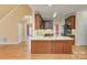 Kitchen view featuring wood cabinets, granite countertops, and a stainless steel refrigerator at 8044 Hawk Crest Ct, Charlotte, NC 28270