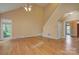 Bright living room with hardwood floors, a ceiling fan, and a large window at 8044 Hawk Crest Ct, Charlotte, NC 28270