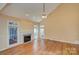 Bright living room with a fireplace, ceiling fan, and hardwood floors at 8044 Hawk Crest Ct, Charlotte, NC 28270
