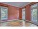 Bright living room with beautiful hardwood floors and multiple windows, offering ample natural light and a spacious feel at 8044 Hawk Crest Ct, Charlotte, NC 28270