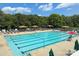 Community pool with multiple lanes, lounge chairs, gazebos, and lifeguard, perfect for summer relaxation at 8044 Hawk Crest Ct, Charlotte, NC 28270