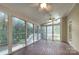 Bright sunroom featuring hardwood floors, three ceiling fans, and plenty of natural light from large windows at 8044 Hawk Crest Ct, Charlotte, NC 28270