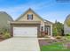 Charming single-Gathering home featuring a brick-accented facade, two-car garage, and a well-manicured lawn at 8450 Norman Forest Rd, Lancaster, SC 29720