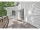 A view of a deck featuring a door with floor-to-ceiling windows on the side of a home at 10101 Wood Ct, Charlotte, NC 28277