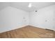 Cozy bedroom featuring a ceiling fan, hardwood floors, and neutral walls at 10101 Wood Ct, Charlotte, NC 28277