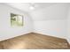 Bright bedroom featuring a window with great natural lighting, hardwood floors, and neutral walls at 10101 Wood Ct, Charlotte, NC 28277