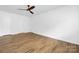 Large bedroom with laminate flooring, white walls, two doors, and a ceiling fan at 10101 Wood Ct, Charlotte, NC 28277