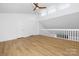 Bonus room featuring a vaulted ceiling, a ceiling fan, hardwood floors, and great natural lighting at 10101 Wood Ct, Charlotte, NC 28277