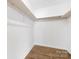 Walk-in closet with wooden floors and shelves to help keep you organized at 10101 Wood Ct, Charlotte, NC 28277
