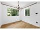 Bright dining room with laminate floors and large windows providing natural light and outdoor views at 10101 Wood Ct, Charlotte, NC 28277