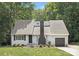 Charming single-story home featuring well-manicured lawn, a black chimney and an attached one car garage at 10101 Wood Ct, Charlotte, NC 28277