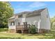 View of the back of the house from the yard showing a modest deck at 10101 Wood Ct, Charlotte, NC 28277