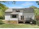 View of the back of the house from the yard showing a modest deck at 10101 Wood Ct, Charlotte, NC 28277