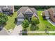 Overhead shot of a beautiful home with manicured lawn, a driveway leading to an attached garage, and mature trees at 10106 Silverling Dr, Waxhaw, NC 28173
