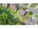 Aerial view of a home with a large backyard, mature trees, a screened in patio and firepit at 10106 Silverling Dr, Waxhaw, NC 28173