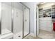 Contemporary bathroom featuring a glass shower stall and an organized walk-in closet at 10106 Silverling Dr, Waxhaw, NC 28173