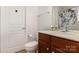 Bathroom featuring dark wood vanity, a white sink, updated fixtures, and a decorative shower curtain at 10106 Silverling Dr, Waxhaw, NC 28173