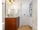 Full bathroom featuring a tile floor, wooden vanity, shower with curtain, and decorative light fixture at 10106 Silverling Dr, Waxhaw, NC 28173