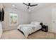 Cozy bedroom featuring a ceiling fan, neutral carpet, and a window with natural light at 10106 Silverling Dr, Waxhaw, NC 28173