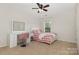 Bedroom with a charming vanity and a bed covered with a red and white checkered comforter at 10106 Silverling Dr, Waxhaw, NC 28173