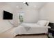 Modern bedroom featuring a ceiling fan, neutral carpet, a window with natural light, and wall mounted tv at 10106 Silverling Dr, Waxhaw, NC 28173