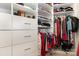 Organized walk-in closet featuring shelving, drawers, rods, and a carpeted floor at 10106 Silverling Dr, Waxhaw, NC 28173