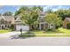 Charming two-story brick home with manicured front yard and attached two-car garage on a sunny day at 10106 Silverling Dr, Waxhaw, NC 28173