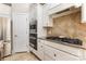 Modern kitchen with granite countertops, stainless appliances, and tile backsplash at 10106 Silverling Dr, Waxhaw, NC 28173