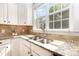 Close-up of kitchen sink featuring granite countertops and natural light at 10106 Silverling Dr, Waxhaw, NC 28173