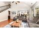 Comfortable living room with open floor plan, wood floors and staircase access at 10106 Silverling Dr, Waxhaw, NC 28173