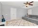 Cozy living room area with carpet, a ceiling fan, and a comfortable gray sofa at 10106 Silverling Dr, Waxhaw, NC 28173