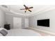 Comfortable main bedroom with a ceiling fan, recessed lights, carpeted floor, and large flatscreen TV at 10106 Silverling Dr, Waxhaw, NC 28173