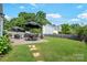 Well-maintained backyard with a stone pathway leading to a patio with a seating area at 1013 Nez Perce Ln, Monroe, NC 28110