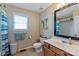Well-lit bathroom featuring a shower with a curtain, a vanity, and a toilet at 1013 Nez Perce Ln, Monroe, NC 28110
