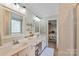 Clean and bright bathroom featuring double sinks, vanity and a walk in shower with neutral decor at 1013 Nez Perce Ln, Monroe, NC 28110