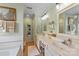 Bright bathroom featuring double sinks, vanity and a walk in shower with neutral decor and a big mirror at 1013 Nez Perce Ln, Monroe, NC 28110