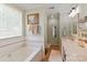 Bright bathroom featuring a tub and shower combination and lots of natural light from a large window at 1013 Nez Perce Ln, Monroe, NC 28110