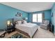 Cozy bedroom with a queen sized bed, grey chair and carpeted floors with a neutral decor at 1013 Nez Perce Ln, Monroe, NC 28110
