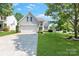 Charming home with a well-manicured lawn, attached garage, and welcoming entrance at 1013 Nez Perce Ln, Monroe, NC 28110