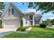 Charming exterior view featuring a well-maintained lawn and inviting front entrance at 1013 Nez Perce Ln, Monroe, NC 28110