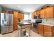 Well-lit kitchen featuring stainless steel appliances and oak kitchen cabinets at 1013 Nez Perce Ln, Monroe, NC 28110